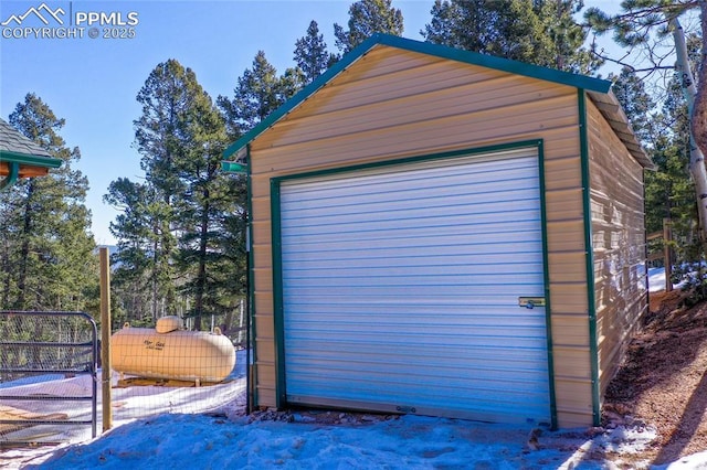 detached garage featuring fence