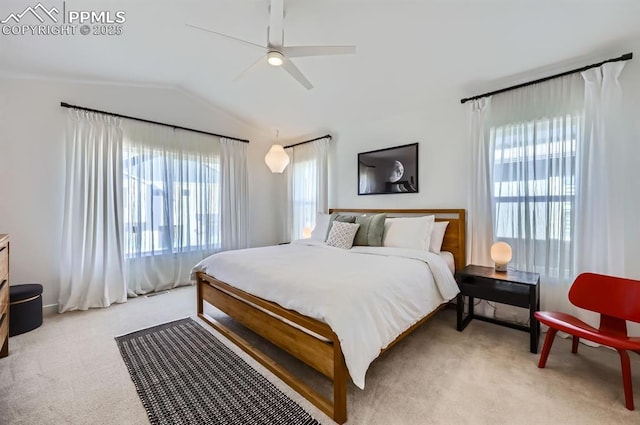 carpeted bedroom featuring lofted ceiling and ceiling fan