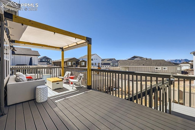 wooden deck featuring an outdoor living space with a fire pit