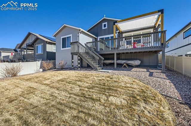 back of house with a deck and a lawn