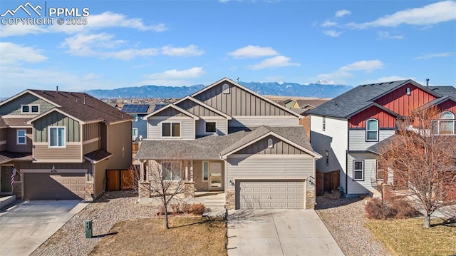 view of front of home featuring a garage, a mountain view, and covered porch