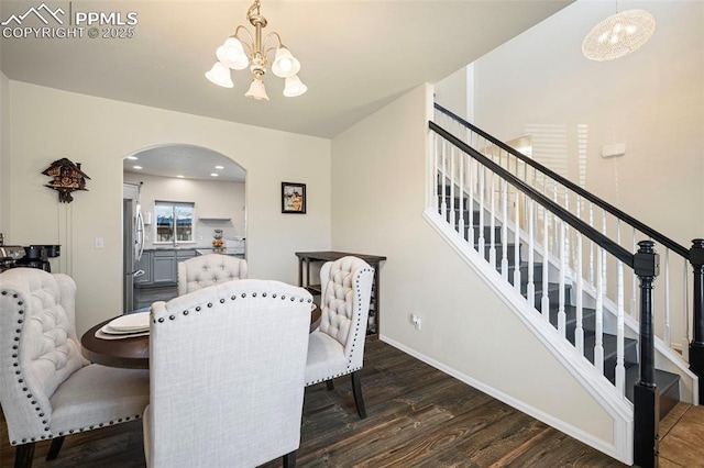 dining area featuring a notable chandelier and dark hardwood / wood-style flooring