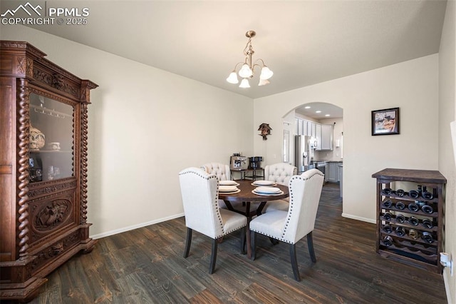 dining area featuring dark hardwood / wood-style floors and a chandelier