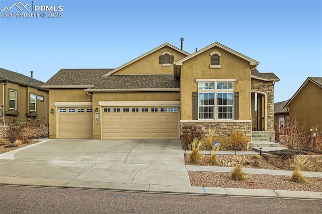 view of front of house featuring stone siding, driveway, an attached garage, and stucco siding