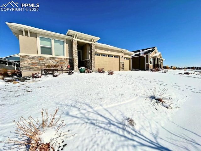 view of front of house featuring a garage, stone siding, and stucco siding