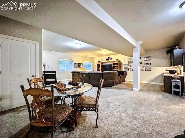 dining area with vaulted ceiling and carpet flooring