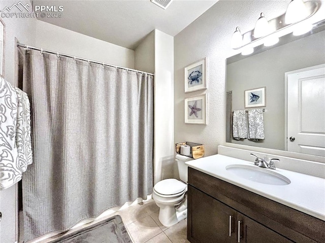 bathroom featuring tile patterned flooring, vanity, and toilet