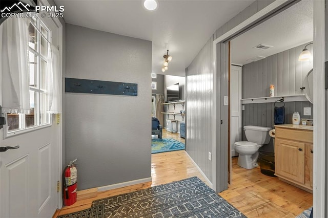 bathroom with wood-type flooring, vanity, and toilet