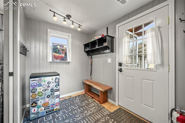 mudroom with wood-type flooring and rail lighting