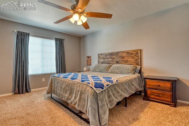 bedroom with a textured ceiling, ceiling fan, and carpet flooring