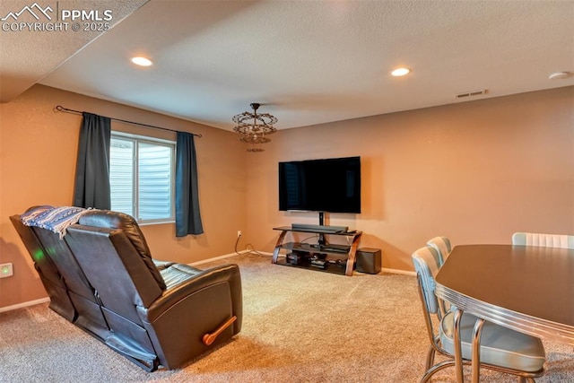 living room featuring carpet floors and a textured ceiling