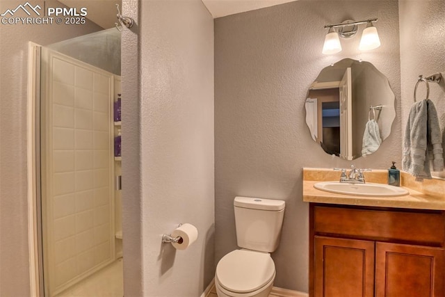 bathroom with vanity, toilet, and walk in shower