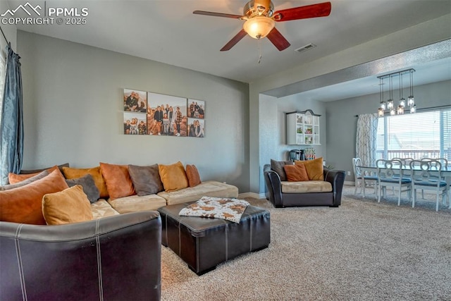 living room featuring carpet and ceiling fan