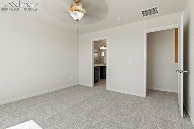 unfurnished bedroom with connected bathroom, light carpet, and ceiling fan