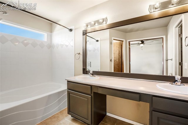 bathroom with tile patterned floors, vanity, tiled shower / bath combo, and ceiling fan