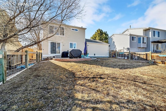 back of property featuring a lawn