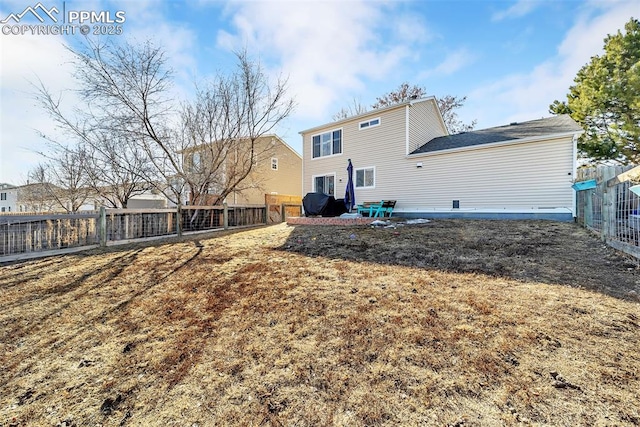 rear view of property featuring a patio area and a lawn