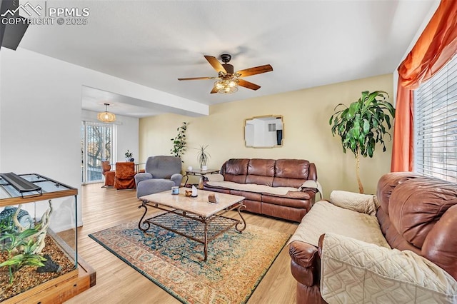 living room with ceiling fan and light hardwood / wood-style flooring