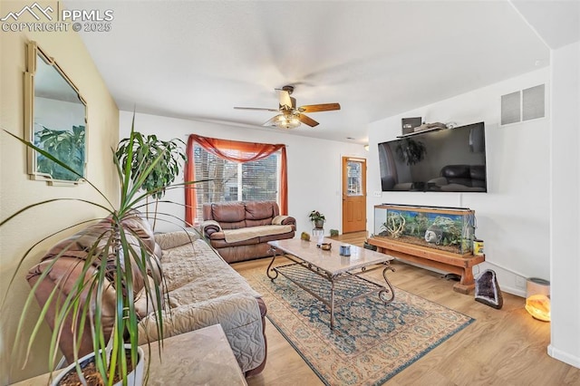 living room with ceiling fan and light wood-type flooring