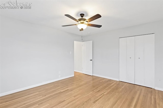 unfurnished bedroom with ceiling fan, a closet, and light wood-type flooring