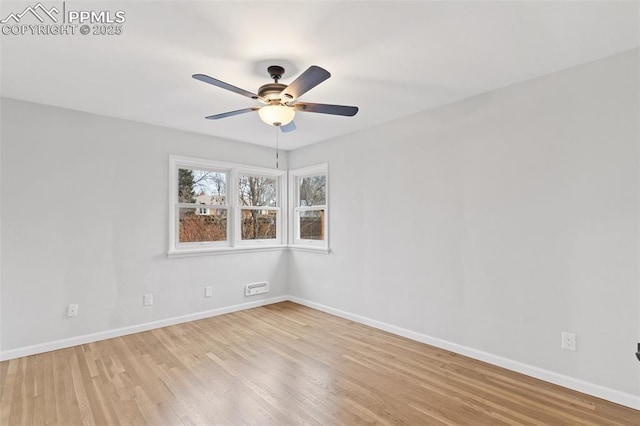 spare room with ceiling fan and light wood-type flooring