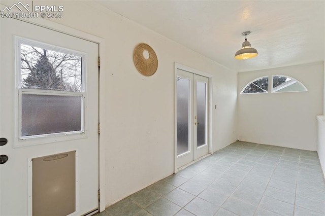 doorway with french doors and light tile patterned flooring