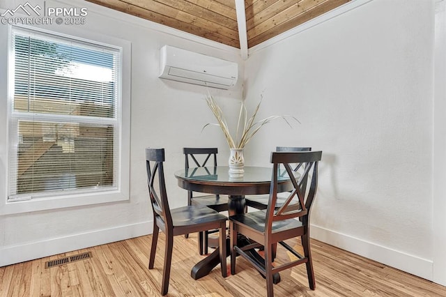 dining area with a wall unit AC, baseboards, visible vents, and wood finished floors