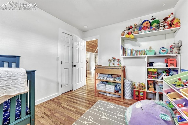 bedroom featuring baseboards and wood finished floors