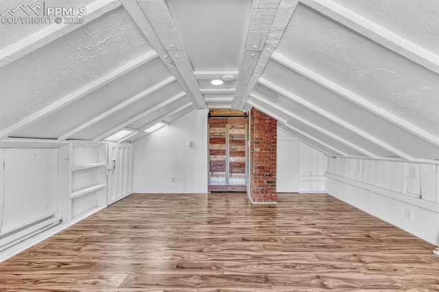 bonus room with lofted ceiling, baseboard heating, and wood finished floors