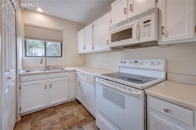 kitchen featuring white cabinetry, sink, a textured ceiling, and white appliances