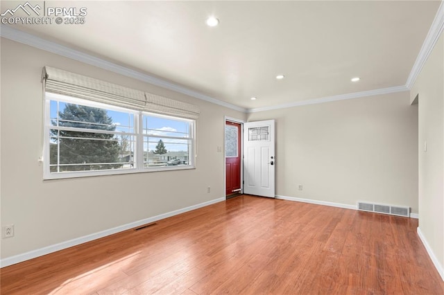 unfurnished room with crown molding and wood-type flooring