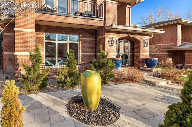 entrance to property with a patio and a balcony