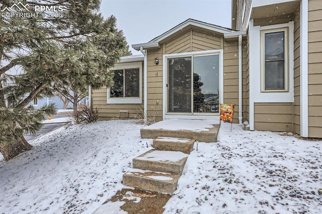 view of snow covered property entrance