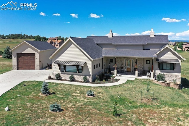 view of front of home featuring a garage, covered porch, and a front lawn