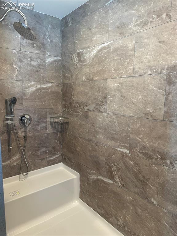 bathroom with a tile shower