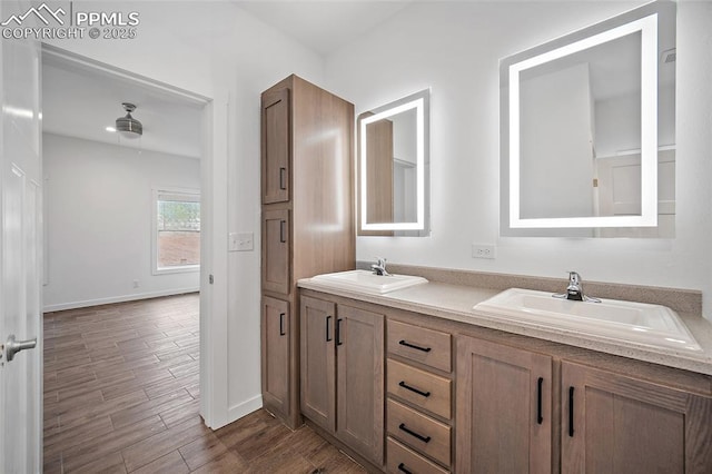 20 Apache Cir, Florissant, CO 80816 - full bathroom with baseboards, wood finished floors, a sink, and double vanity