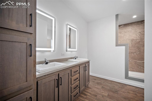20 Apache Cir, Florissant, CO 80816 - bathroom featuring baseboards, wood finished floors, a sink, and double vanity