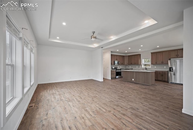 20 Apache Cir, Florissant, CO 80816 - kitchen with light countertops, a raised ceiling, appliances with stainless steel finishes, and open floor plan
