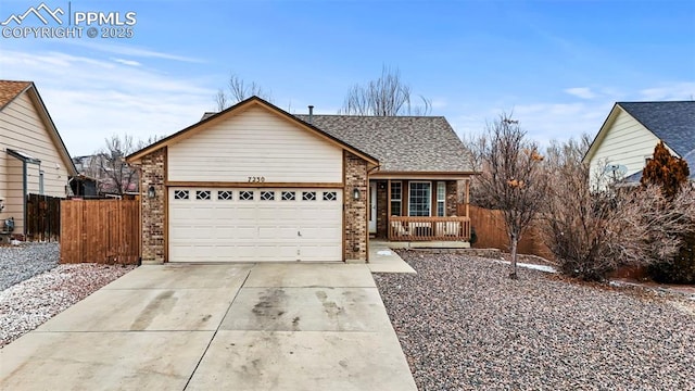 ranch-style house featuring brick siding, driveway, an attached garage, and fence