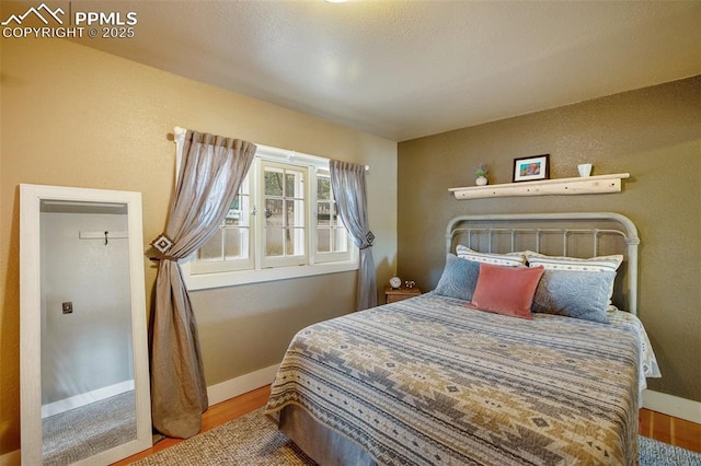 bedroom with hardwood / wood-style flooring