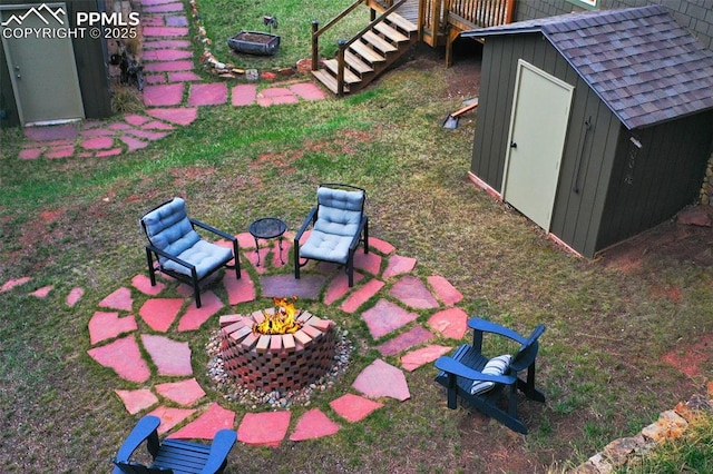 view of yard with a storage unit and a fire pit