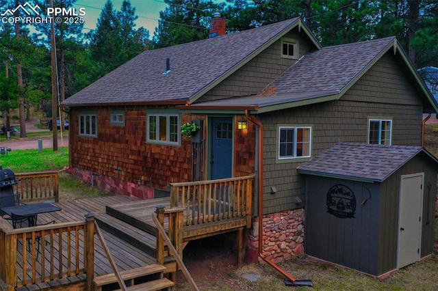 rear view of property featuring a deck