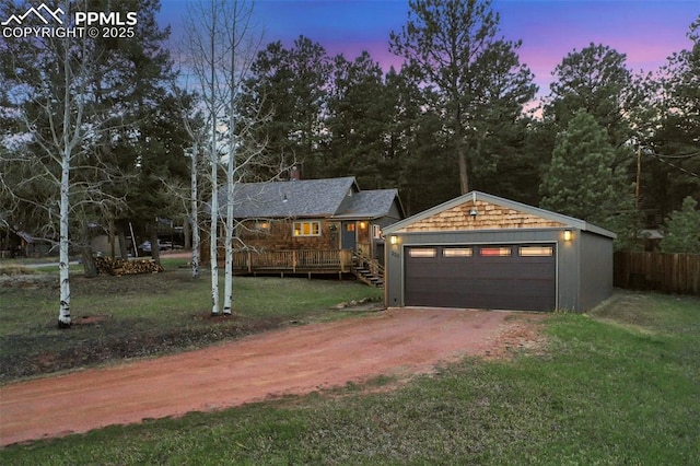 view of front of house with a deck and a lawn