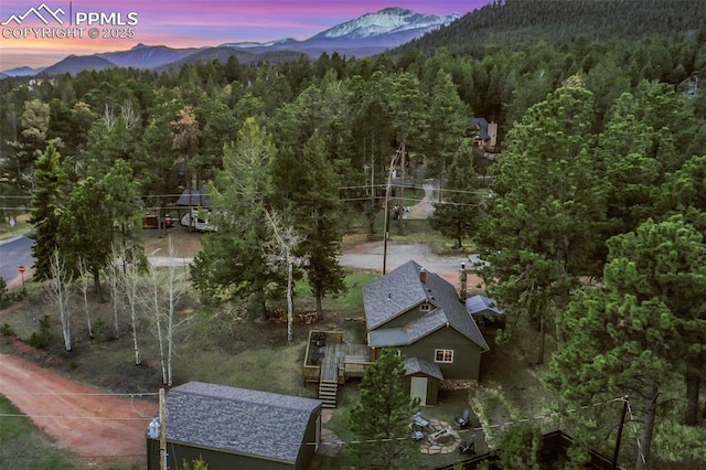 aerial view at dusk featuring a mountain view