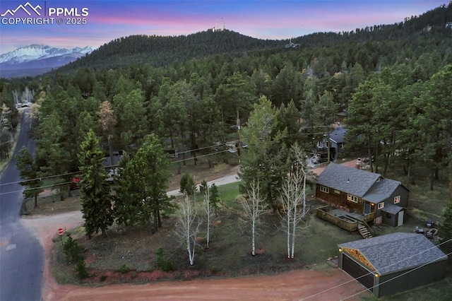 aerial view at dusk featuring a mountain view