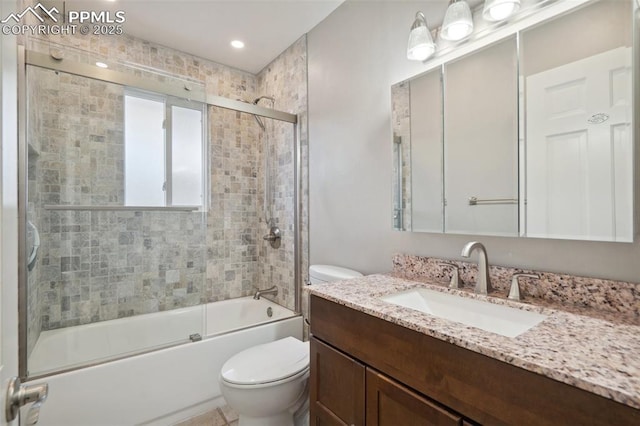 full bathroom with toilet, vanity, and shower / bath combination with glass door