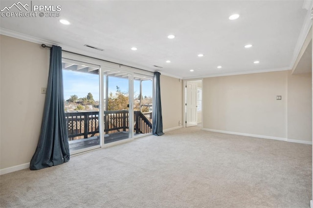 carpeted spare room featuring crown molding