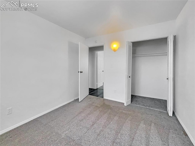 unfurnished bedroom featuring dark carpet and a closet