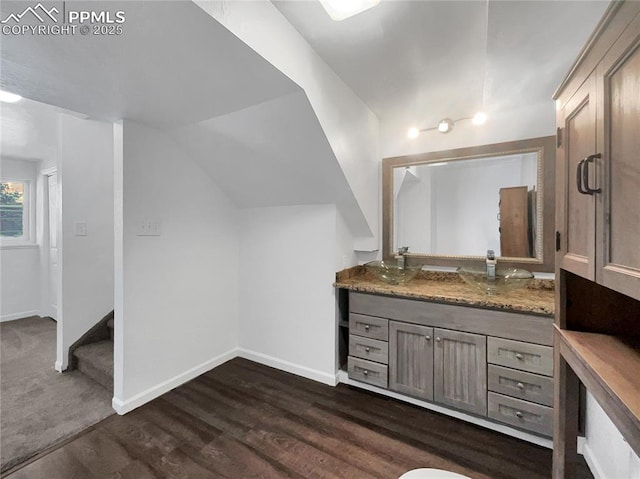 bathroom with lofted ceiling, vanity, and hardwood / wood-style flooring