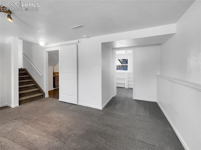 basement with dark colored carpet